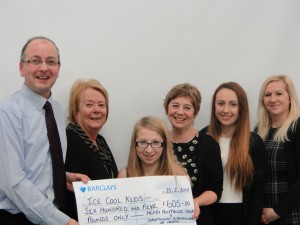 Pictured from left to right:  Choir Director, Mark Ritzmann with Soroptimist representative, Bethan Evans are seen presenting a cheque to Mrs.Julie Harvey and young members of Ice Cool Kids.   